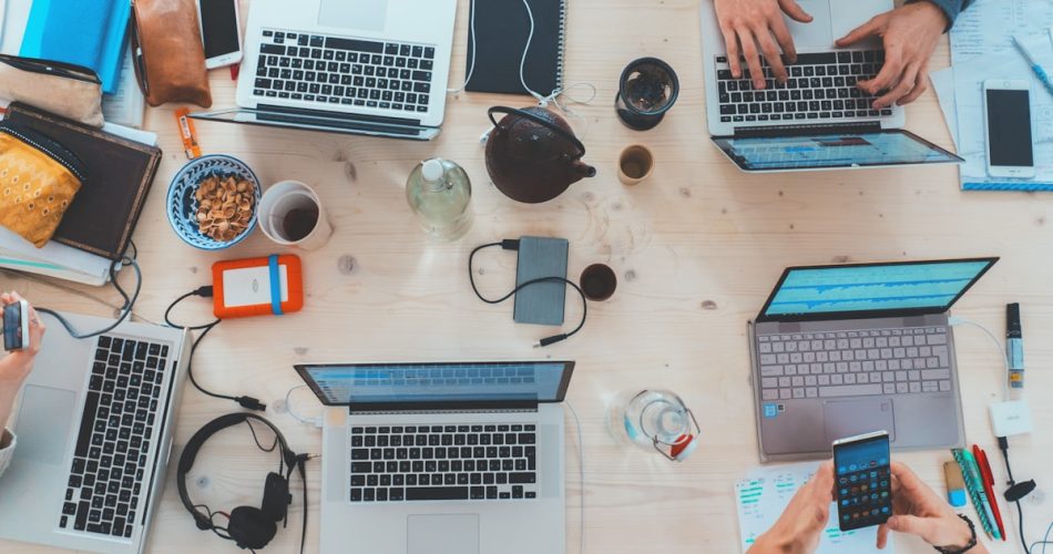 Modern desk with laptop and smartphone - productivity tools