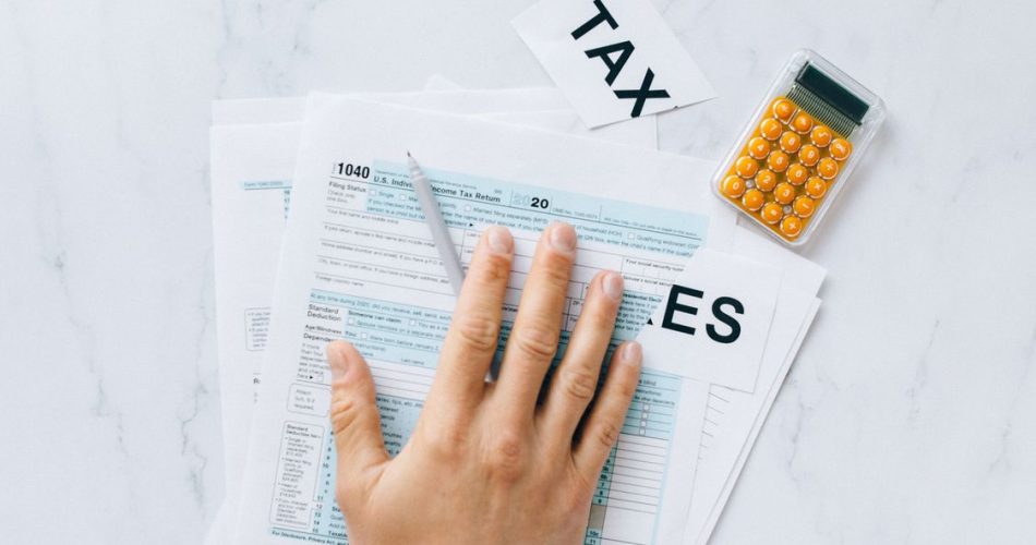 Nepal tax filing document and calculator on office desk - Finance Act 2083 amnesty